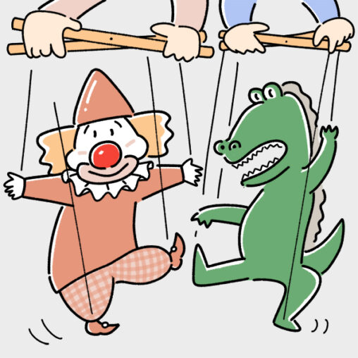 ピエロとワニの人形を操るこども